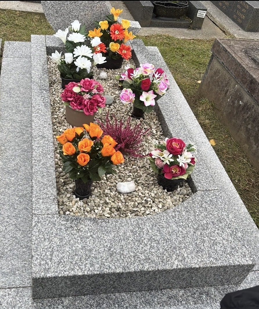 Grave after the service, cleaned and decorated with flowers